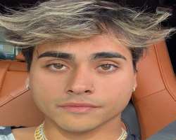 The star has piercing in his ears and nose.